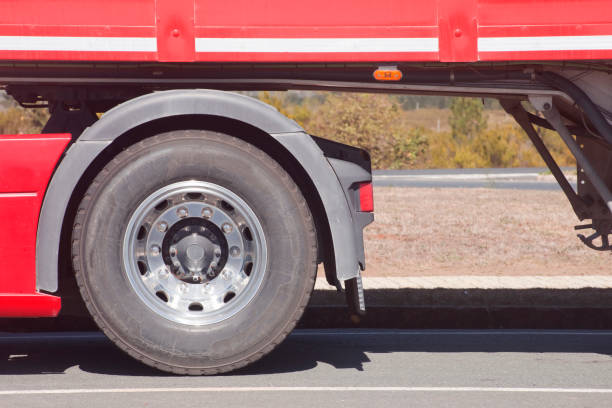 Semi Truck Heavy Duty Tires and Chromed Alloy Wheels. Driving in a Heavy Rain Conditions. Modern Truck Tractor Rear Wheels. Automotive Industry.
