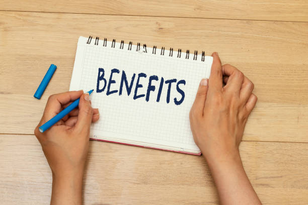 istock woman hands writing benefits concept on notebook 1251297973