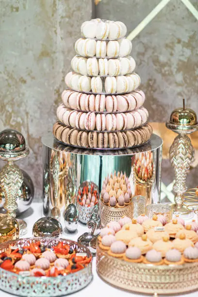 Delicious sweets on candy buffet. Candy bar on wedding ceremony with a lot of different candies. Details of a tasty candy bar of sweets, cookies , sweets concept.