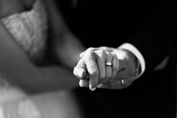 istock Couple. You can see the hands touching each other. 1251302710