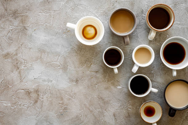 istock Coffee addiction. Many of cups on hrey table top view space for text 1251303311