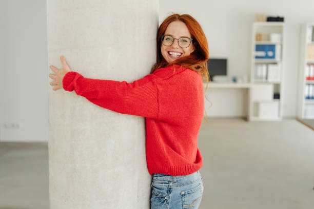istock Friendly young woman with a beaming happy smile 1251303932