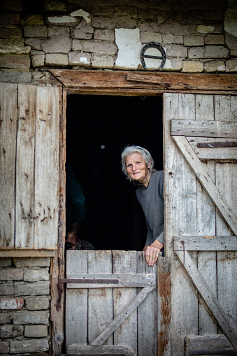 Old woman on her doorstep