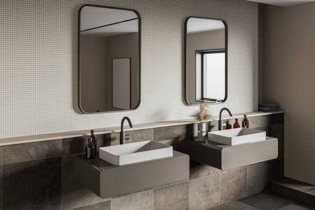 istock Beige and tiled bathroom corner with double sink 1251304343