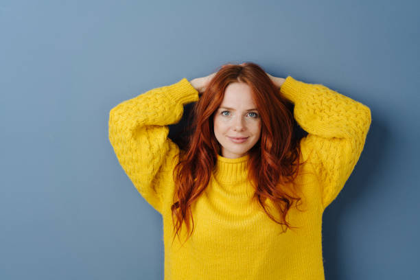 istock Attractive redhead woman posing with raised arms 1251304399