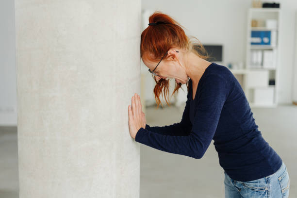 istock Young woman throwing a temper tantrum at work 1251304684