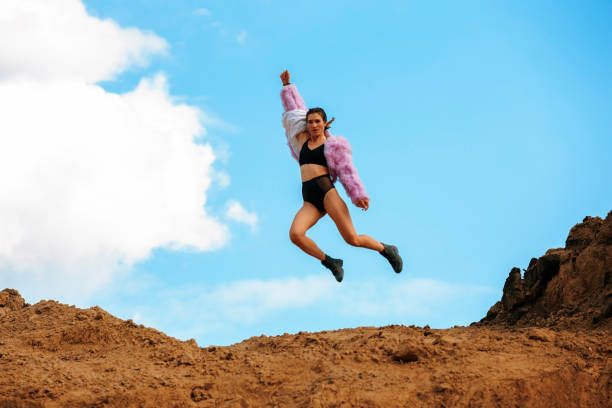 istock Jumping sporty woman 1251304725