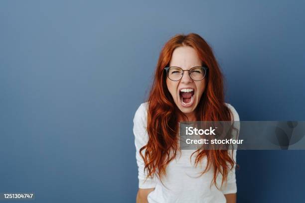 Angry Young Woman Throwing A Temper Tantrum Stock Photo - Download Image Now - Shouting, Screaming, One Woman Only