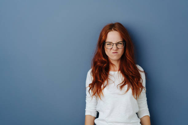 istock Young woman grimacing in revulsion and aversion 1251304777