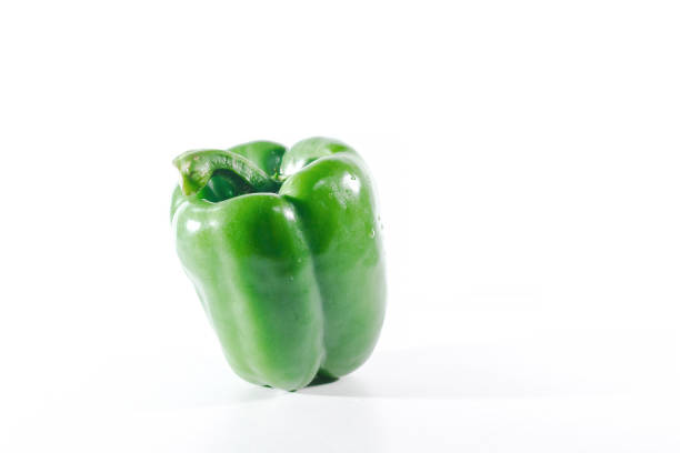 Green bell peppers on a white background, bell peppers are used for cooking and to be eaten fresh, bell peppers are non-spicy bell peppers.