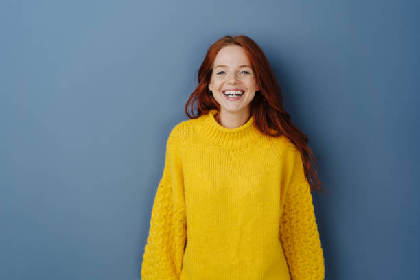 istock Joyful young redhead woman laughing at camera 1251305491