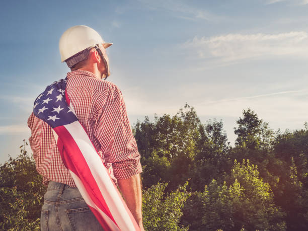 istock Young engineer, white hardhat and American Flag 1251305500