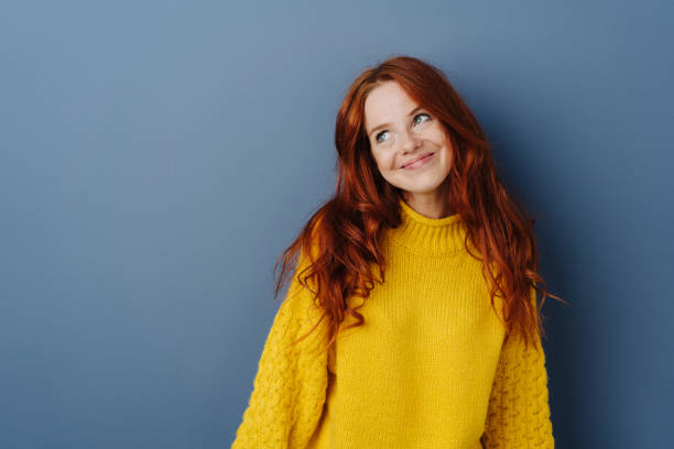 istock Simpering young woman with a coy smile 1251305579