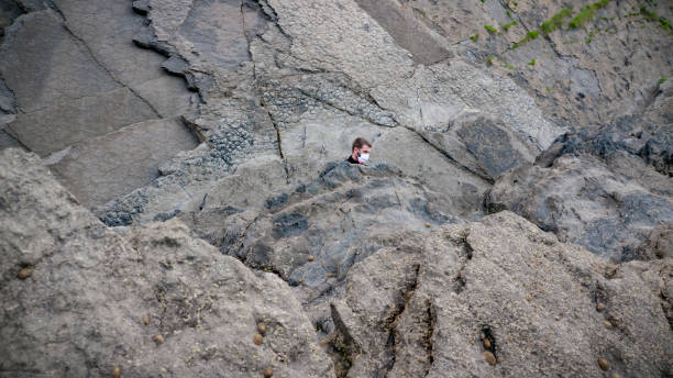 istock Man among coastal rocks 1251305877
