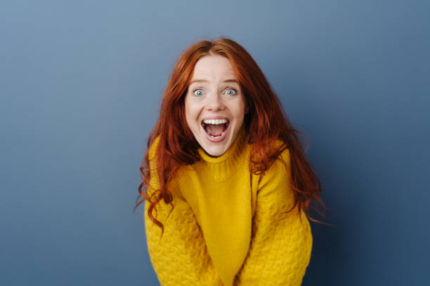 istock Laughing delighted young woman leaning forwards 1251305942
