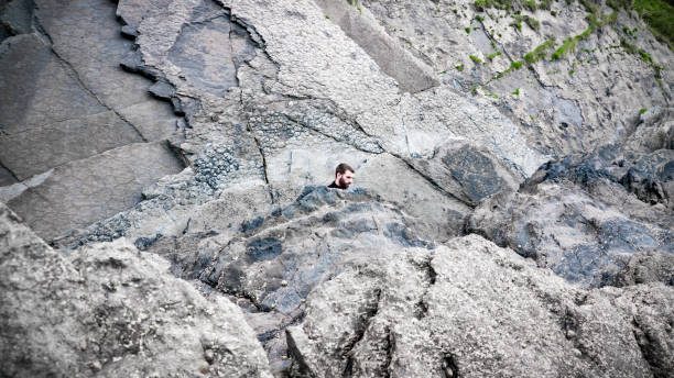 istock Man among coastal rocks 1251307092
