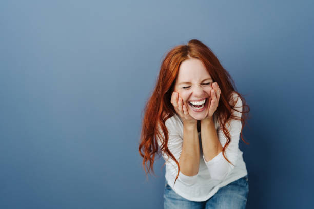 istock Fun young woman enjoying a good joke 1251307135