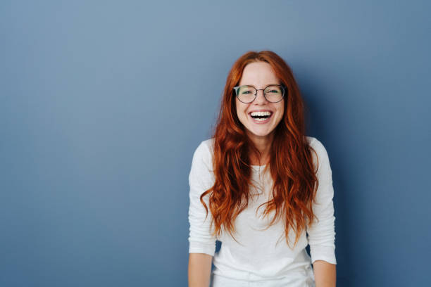 istock Fun loving happy young woman standing laughing 1251307397