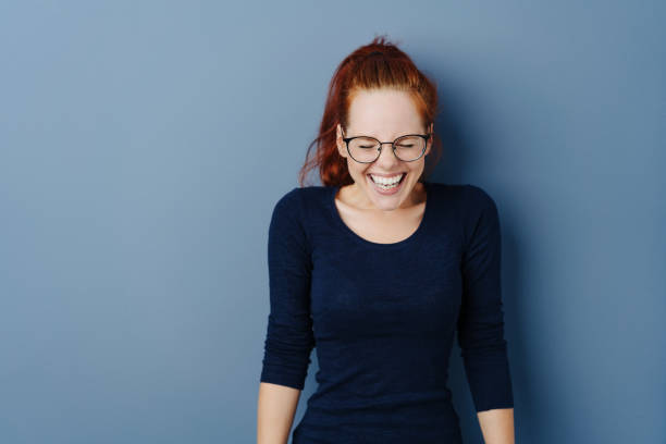 istock Cute young woman giggling to herself 1251307400