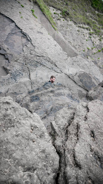 istock Man among coastal rocks 1251307427
