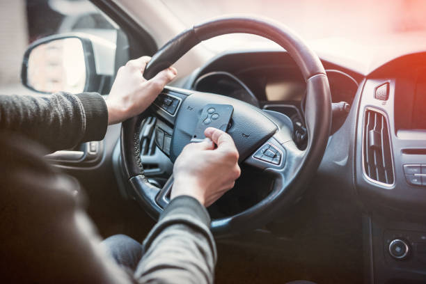 istock dollar and car key in male's hand inside car 1251307841