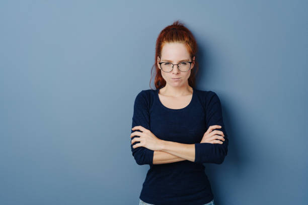 istock Pugnacious young woman glaring at the camera 1251308479