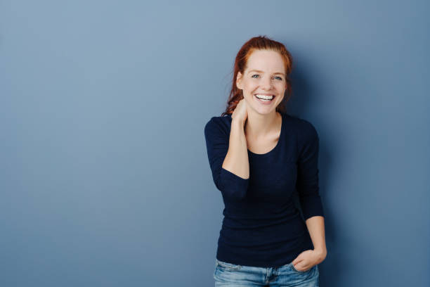 istock Cute casual young redhead laughing at the camera 1251308481