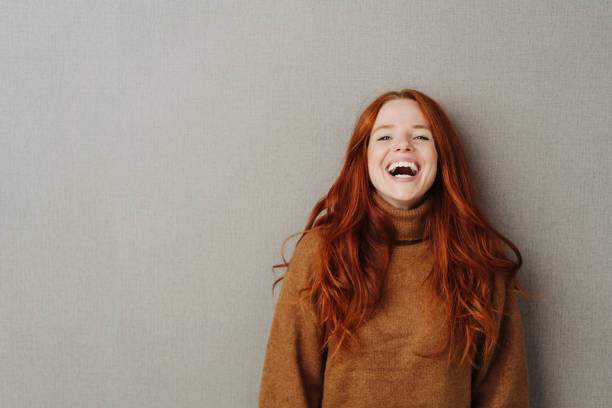 istock Laughing young woman with vivacious smile 1251308482