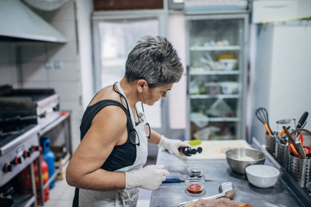 istock Senior female chef in restaurant kitchen 1251308544