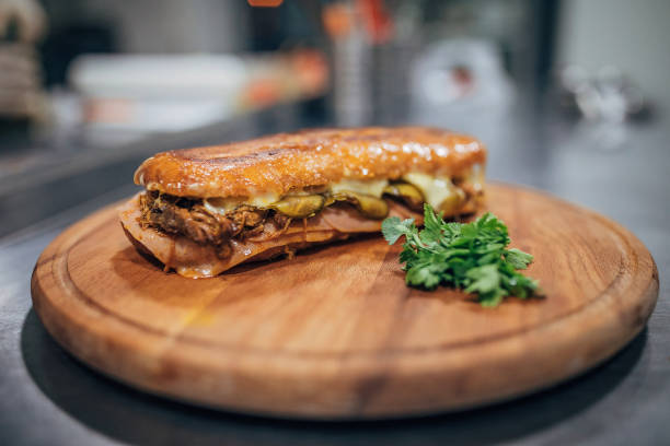 Chopped meat sandwich with grilled cheese, ham and pickles