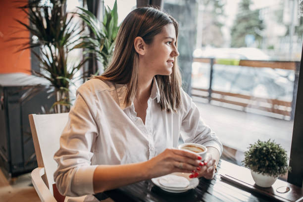 istock Young lady enjoying in coffee alone in cafe 1251310591