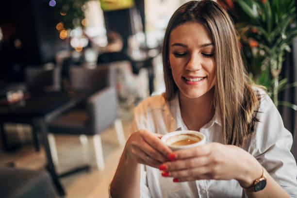 istock Young woman enjoying in coffee alone in cafe 1251310649
