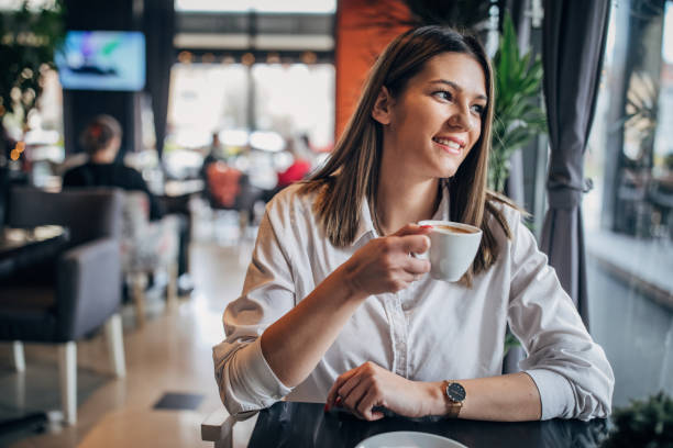 istock Young woman sitting alone in cafe 1251310680