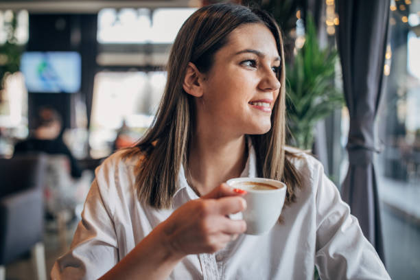 istock Young woman sitting alone in cafe 1251310813