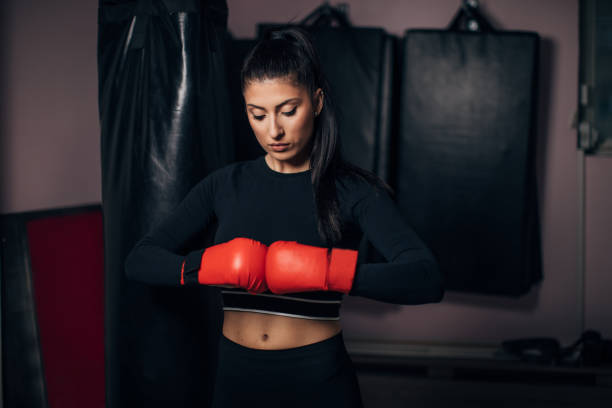 istock Woman with boxing gloves 1251312892
