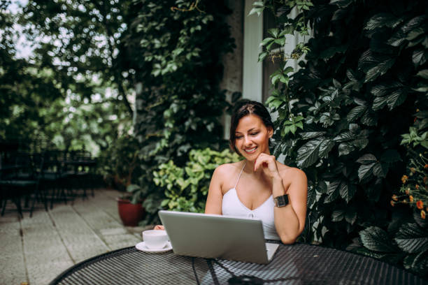 istock Female entrepreneur enjoying in beautiful outdoors cafe. 1251314067