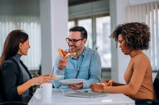 Work To Eat 1,900+ Colleagues Eating Pizza Stock Photos, Pictures & Royalty-Free ...