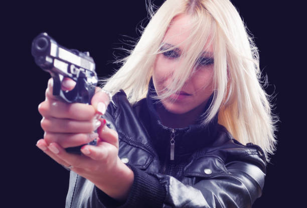istock Young woman shooting the handgun 1251315633