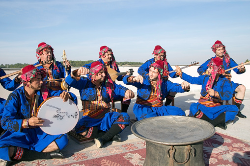 10/30/2013 - Bilecik,Turkey.Folk poets sing in authentic costume.Pelitözü Lake in the back.