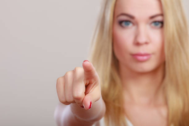istock woman pointing you with finger 1251315679