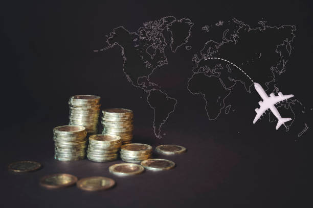 istock Coins Stack, calculator, virtual hologram world map and airplane. Concept of money saving, financial, travel. Savings money,income Investment ideas, management. Digital marketing. 1251315978