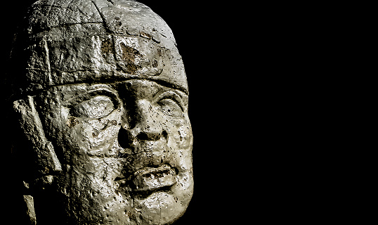 Mexican pre hispanic culture head sculpture over black background