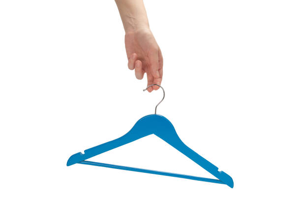 istock Blue hanger in woman hand isolated. 1251319666