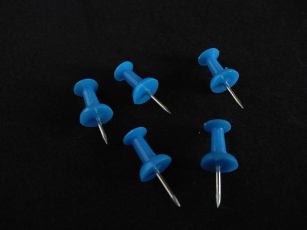 istock Colorful blue push pin isolated on black background.office thumbtack 1251319796