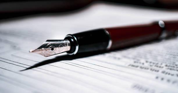 istock Signing the contract document with fountain pen, close-up shot. 1251321272