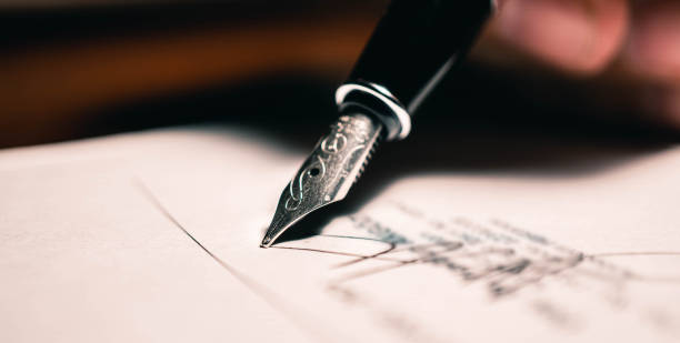 istock Signing the contract document with fountain pen, close-up shot. 1251321275