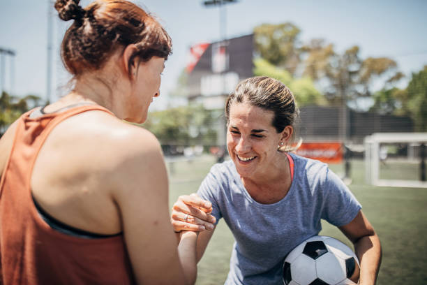 istock Women handshake on a soccer field 1251321380