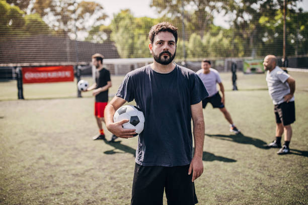 istock Men standing outdoors on soccer field 1251323275