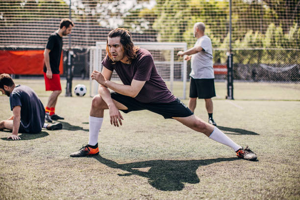 istock Man stretching on soccer field 1251323584