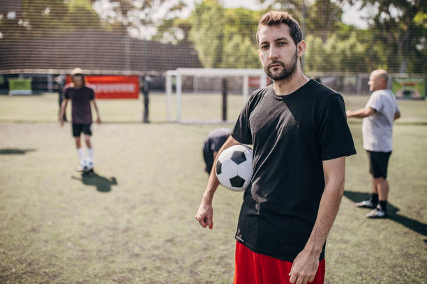 istock Man standing on soccer field 1251323643